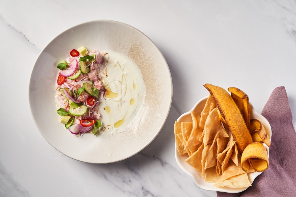 A bold and creamy fusion of Leche de Tigre and coconut milk, elevated with the bright heat of Fresno pepper and a smoky finish from Morita chili oil.