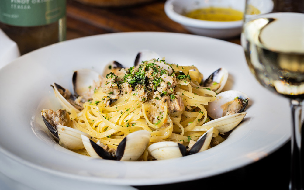 Linguine pasta tossed with baby clams, garlic, and parsley in a white wine sauce