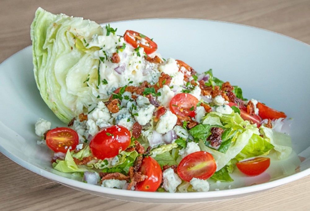 Chopped Wedge Salad | Applewood Smoked Bacon, Bleu Cheese, Red Onion, Sweet Grape Tomatoes, Italian Vinaigrette, Bleu Cheese Dressing