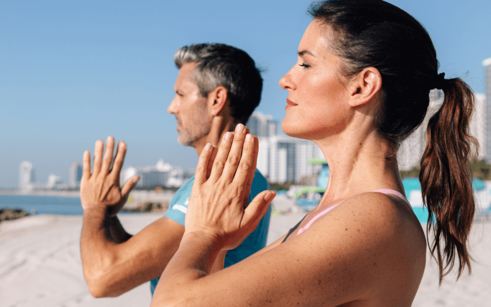 Guests embrace mindfulness and movement with guided yoga on the soft sands of Miami Beach, steps from The Palms.