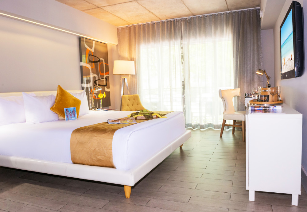 The Balcony guest room has an urban-like metropolitan flair, featuring one queen-size bed. A sliding glass door opens out to a furnished chrome balcony with the views of the effervescent bustle of Miami Beach. A sleek desk comes in every room, along with post-modern leather furniture throughout. Rustic concrete ceilings blend with panoramic silk draperies accent the polished wooden floors. Tempurpedic pillow-top custom beds are dressed in comforters made from 100% organic cotton. Each oversized bathroom comes complete with a rainfall shower, terry cloth bathrobes, slippers and Bigelow bathroom products. Located just one block from the ocean and near Lincoln Road, Miami Beach Convention Center, and other popular local attractions.