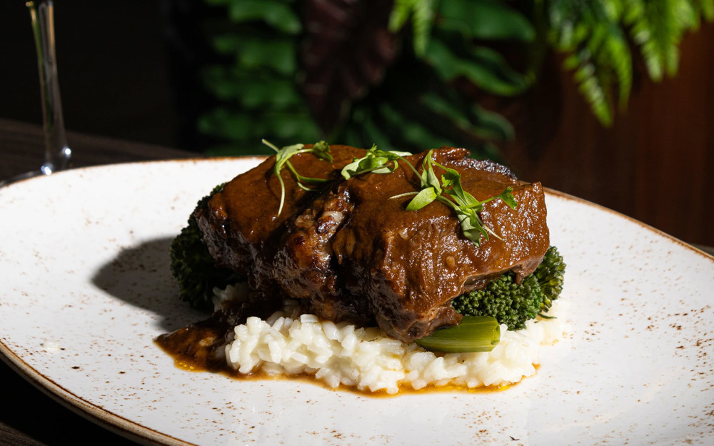 Slowly braised for 48 hours on top of a parmesan risotto bed and broccolini.