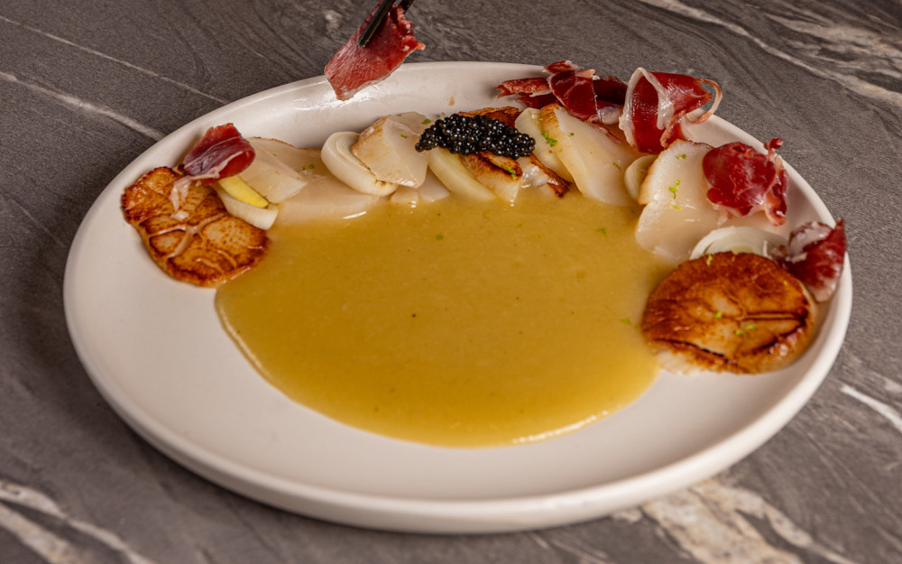 Creamy leek soup, pickled leeks, and 5J Iberian ham.