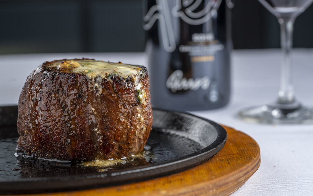 Seasoned with Perry’s Signature Steak Seasoning, served on a hot cast iron plate, and topped with Perry's Steak Butter