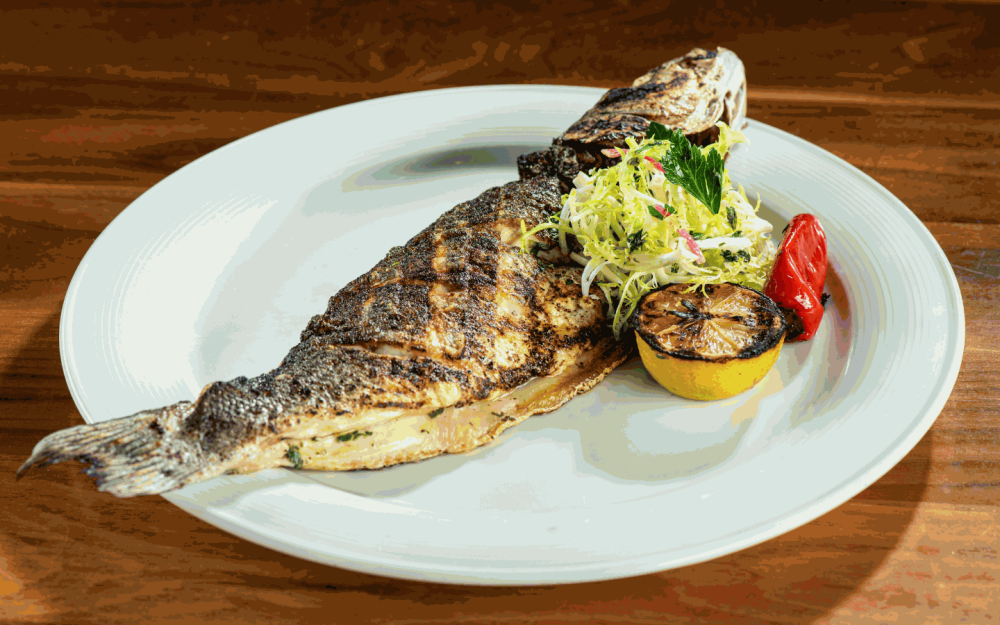 Discover a culinary journey beyond steak at Bourbon Steak Miami, where the crispy Whole Branzino steals the show with its delicate flavors.