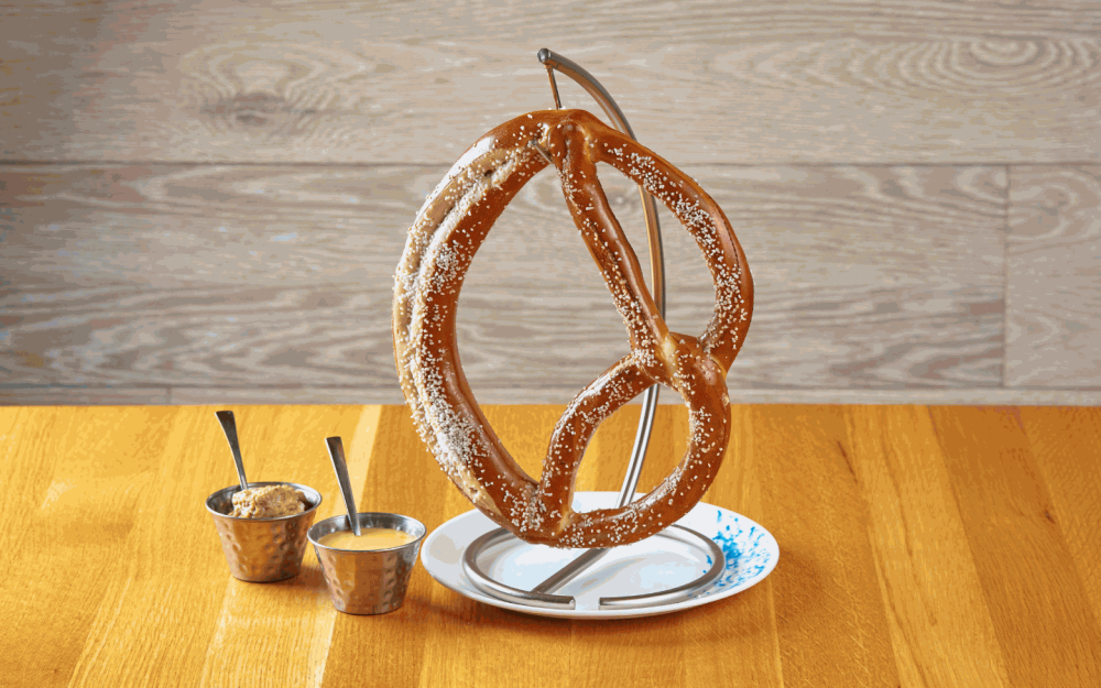 The incredible Soft and Warm Salted Pretzel on the Hanger comes with cheese sauce and craft beer mustard sauce.
