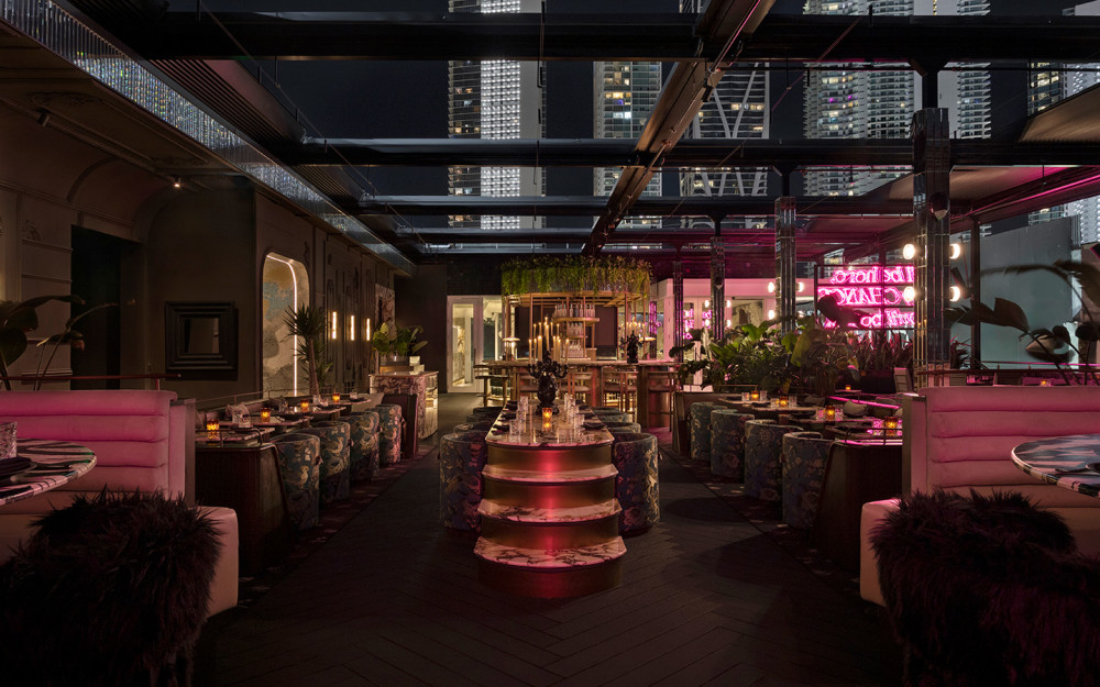 Giselle Miami’s stylish dining room features plush seating, vibrant lighting and elegant décor in an intimate rooftop setting