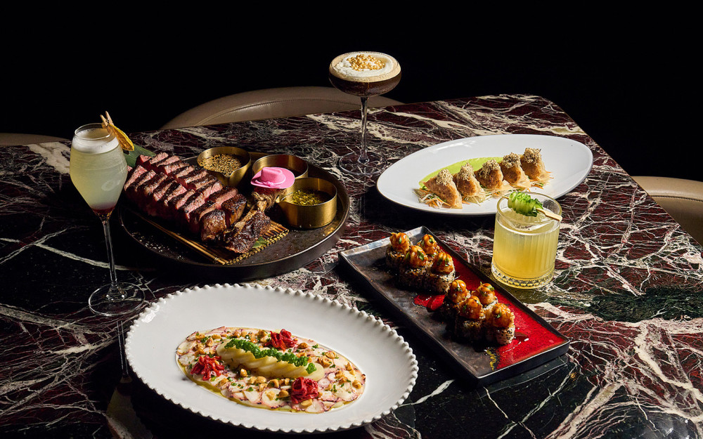A selection of Giselle Miami dishes, including sliced steak, sushi and dumplings, paired with signature cocktails