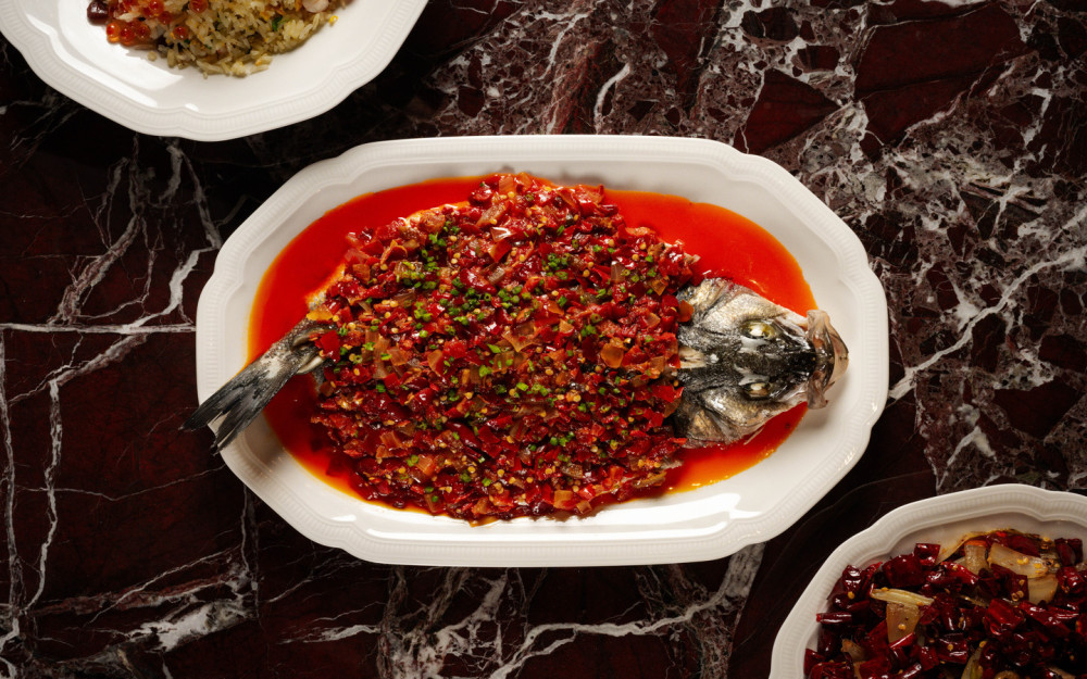 An image of our Hunan Chili Sea Bas garnished with flowering chives