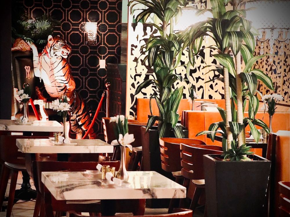 The main dining room at Montana’s Miami Beach features bold décor, lush greenery and an intimate atmosphere.