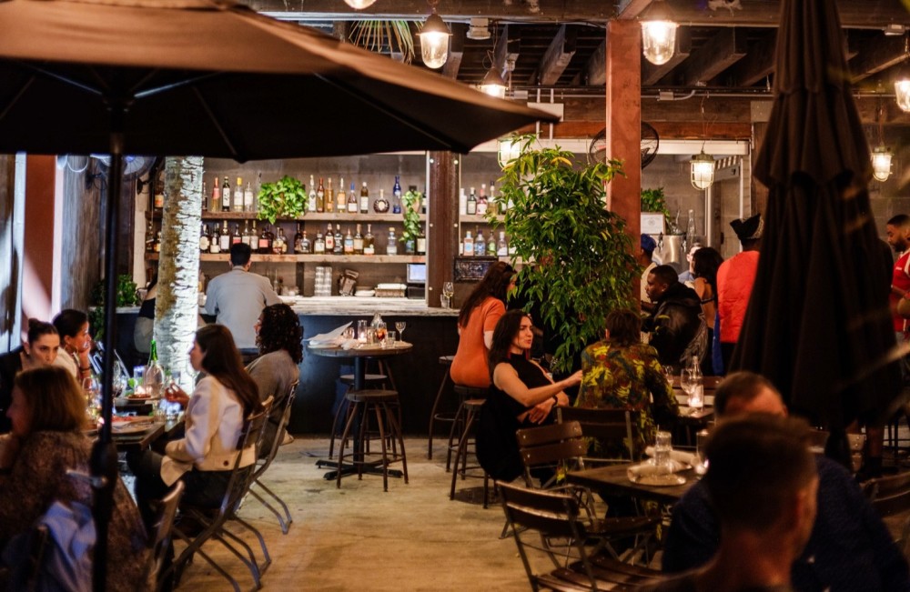 A lively patio bar with warm lighting and a relaxed, inviting atmosphere.