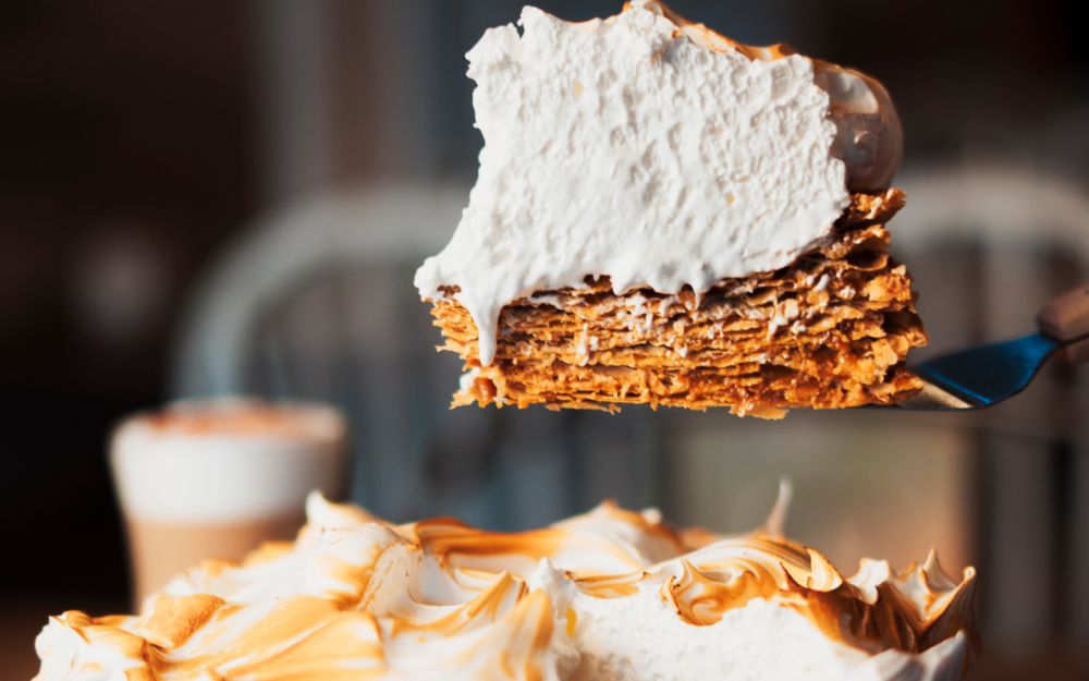 A classic Rogel, made with delicate crispy layers, rich dulce de leche, and topped with fluffy Italian meringue.