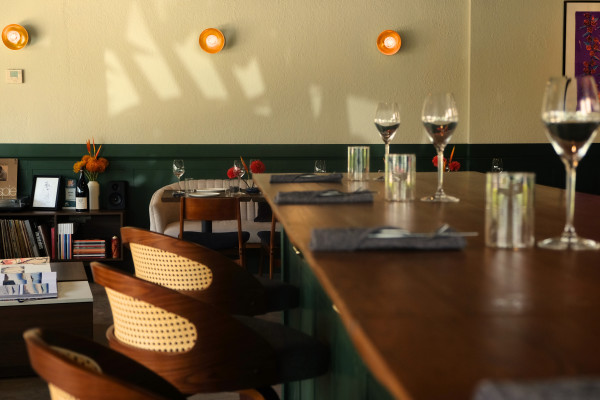 A glance at Kojin's dining room from the front bar during golden hour.