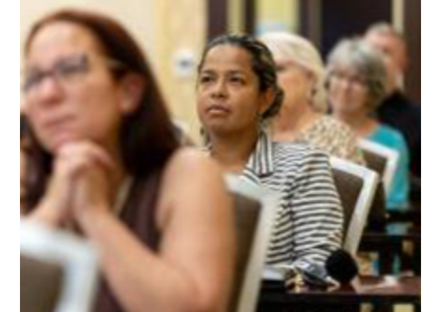 Image of people attending a meeting at the Embassy Suites Fayetteville