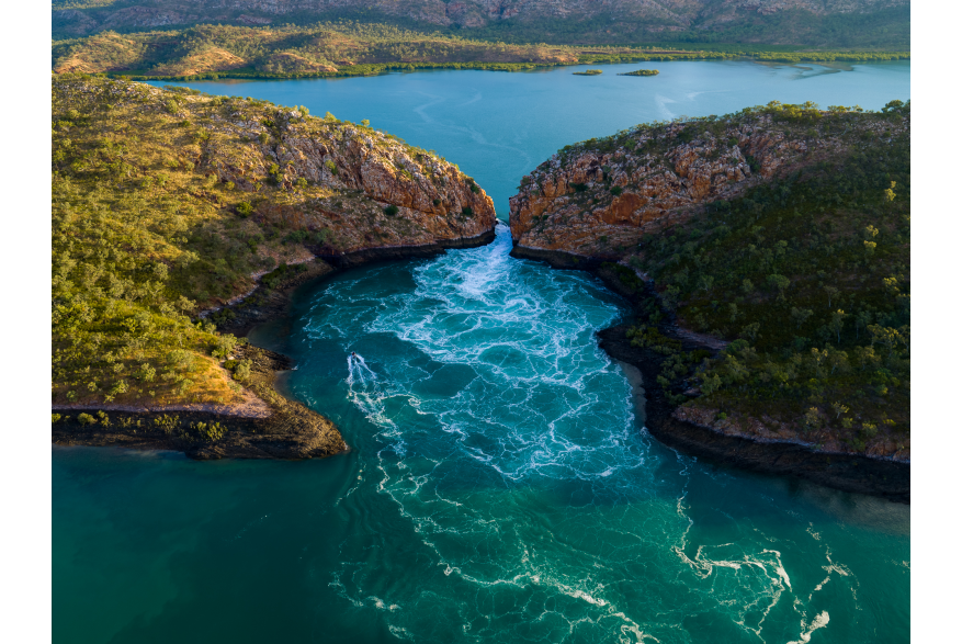 An aerial view of the tide flowing through the narrow gap at the Horizontal Falls on the Kimberley Coast