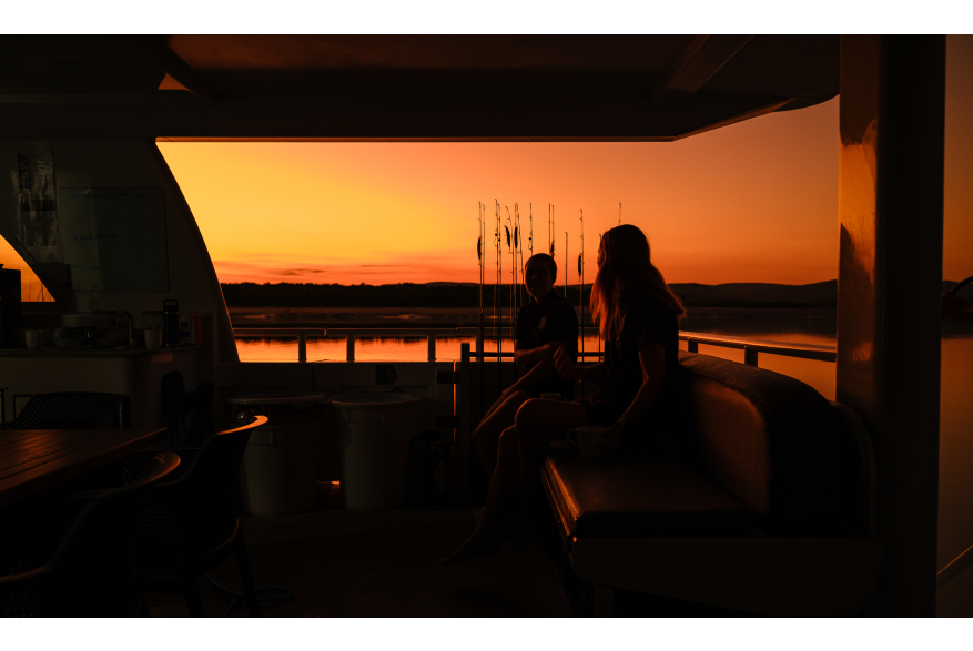 Unwind on deck as the Kimberley sky lights up at sunset.