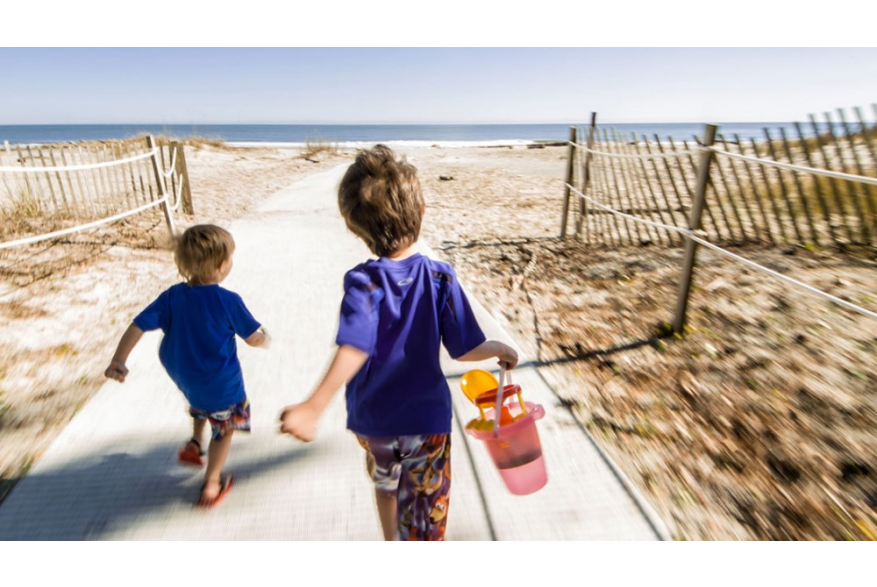 Kids run toward the beach in Beaufort, SC