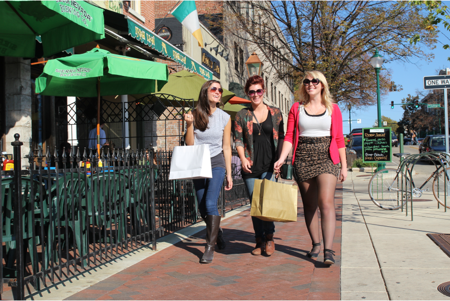 Woman walking downtown carrying shopping bags