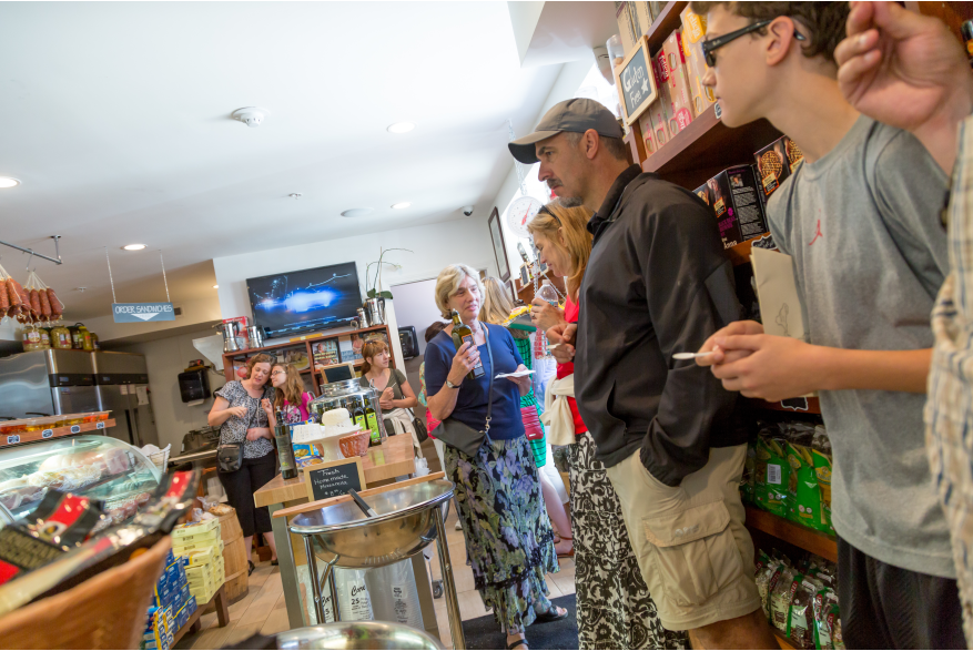 Guests taste olive oil during a walking tour of North End eateries