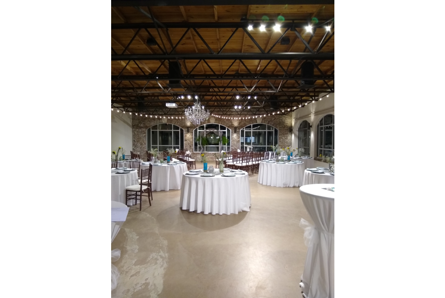 Room with tables decorated for a wedding reception