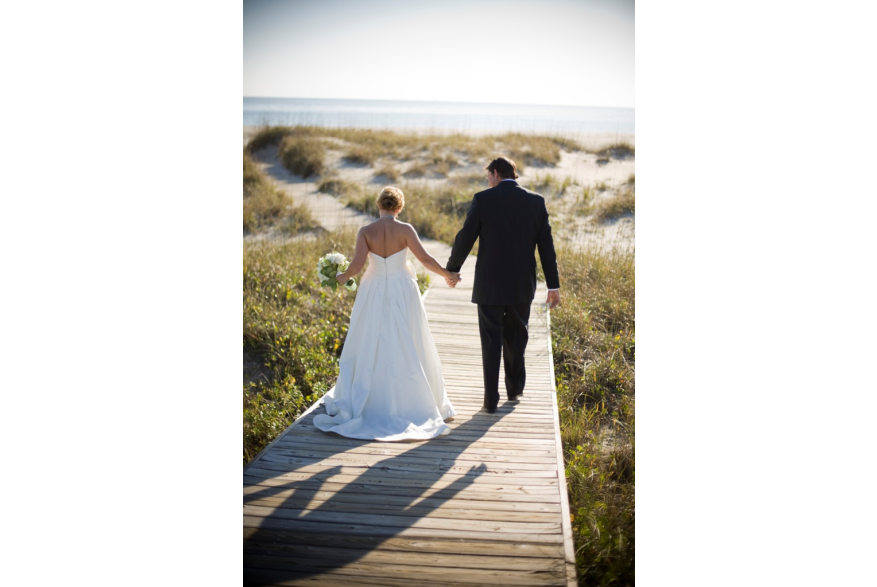 married couple walking on board walk