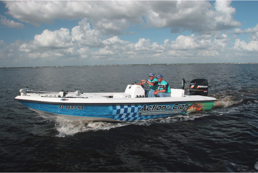 Two people in matching clothing on an "Action Craft" boat on Charlotte Harbor