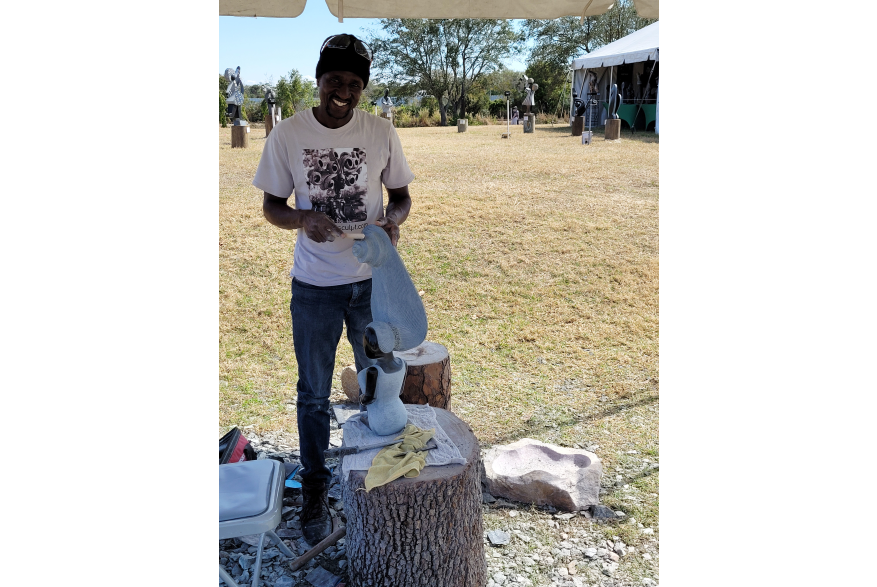 Zimbabwean artist works on a sculpture at Peace River Botanical & Sculpture Gardens