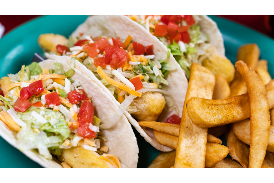 A plate of tacos and french fries