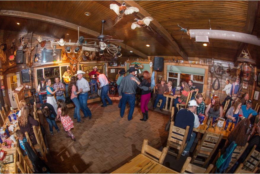 Couples dancing to country music at the Bunkhouse bar