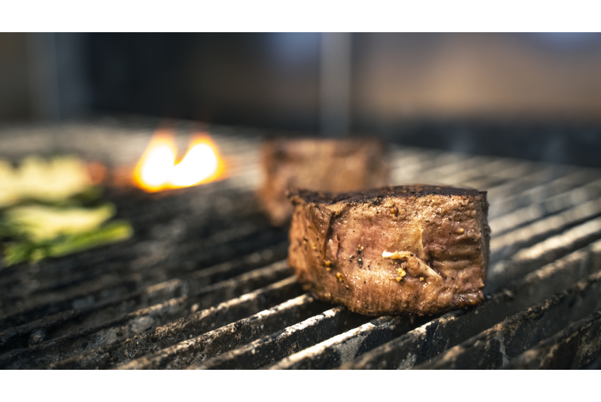 a filet mignon on the grill at the Metropolitan Downtown