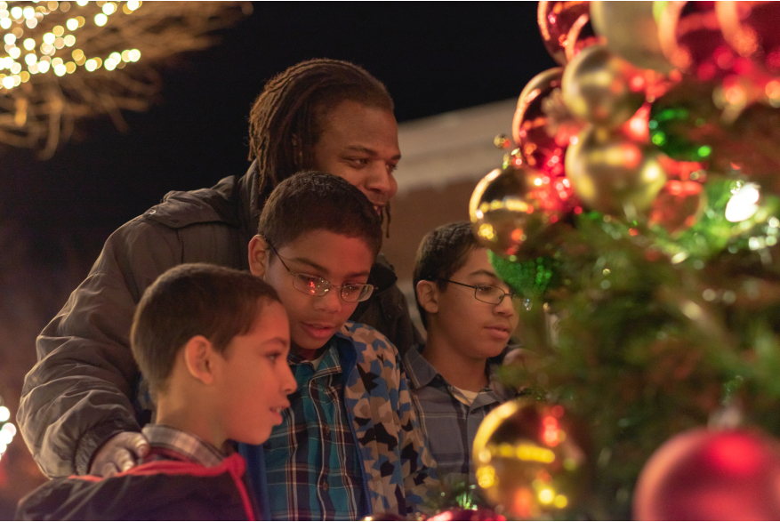 family looking at a Christmas Tree