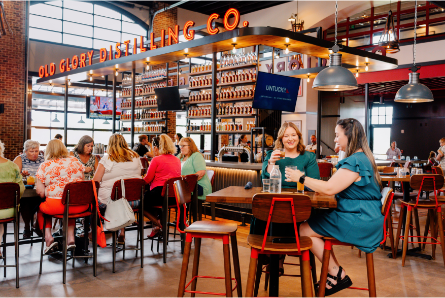 People enjoying food and drinks at the restaurant at Old Glory.