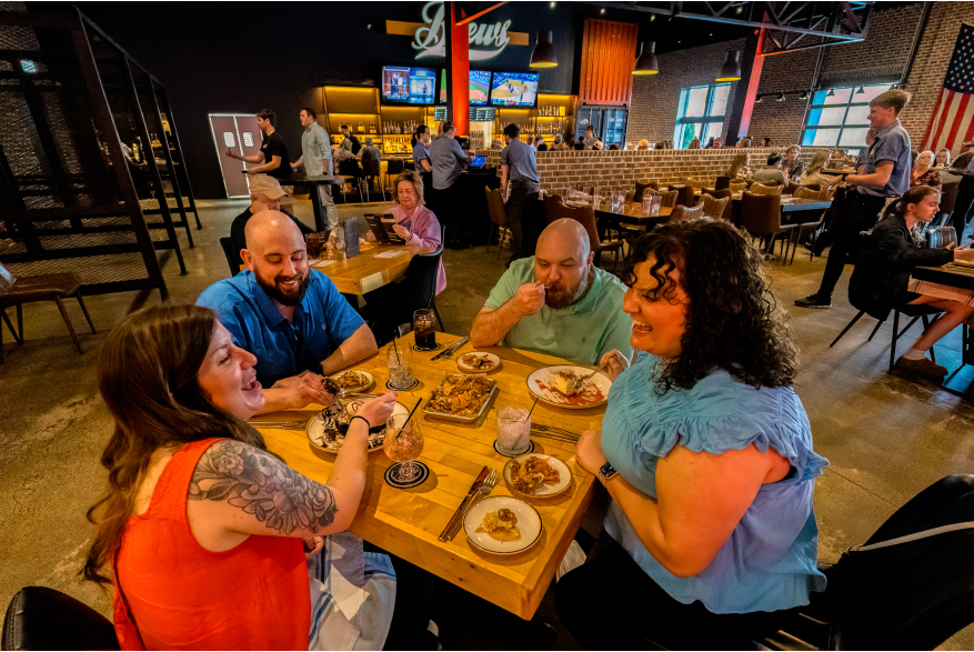 group of people enjoying food in a restaurant