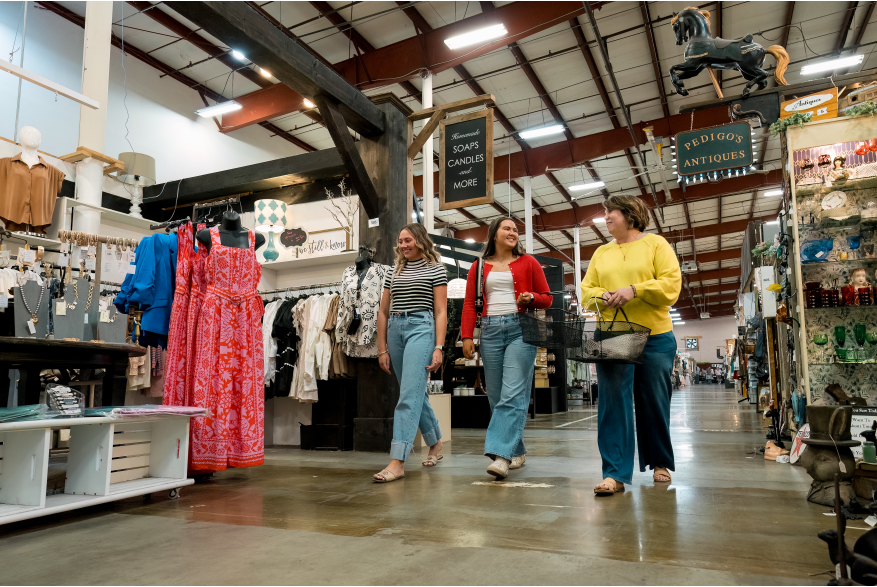 three ladies walking in a large shopping complex