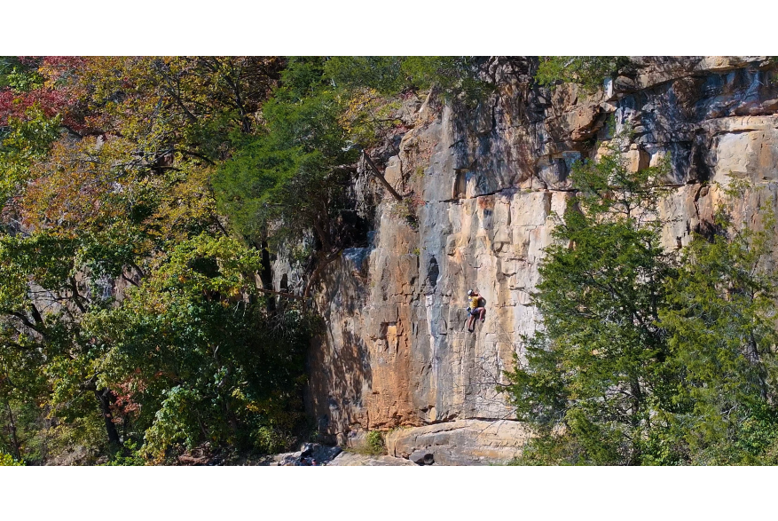 Zoomed out shot of kings bluff with climber.