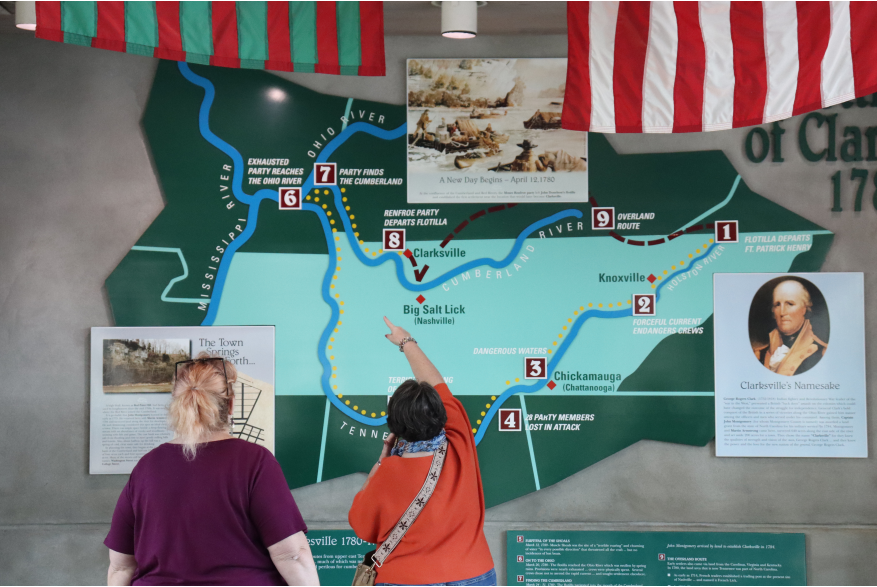 two ladies studying a wall map of the Cumberland River and its tributaries