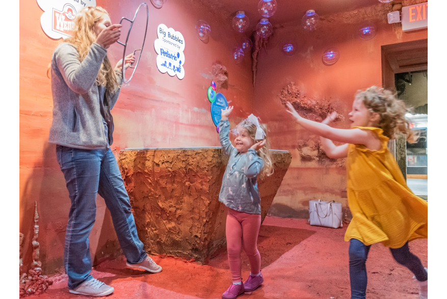 Family enjoying bubble cave in Customs House Museum, Clarksville, TN.