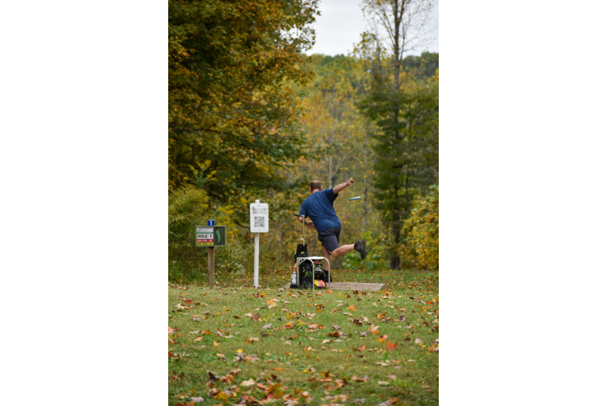 Man throwing disk golf at Rotary Park