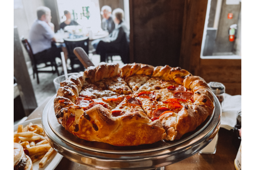 pizza with people in the background
