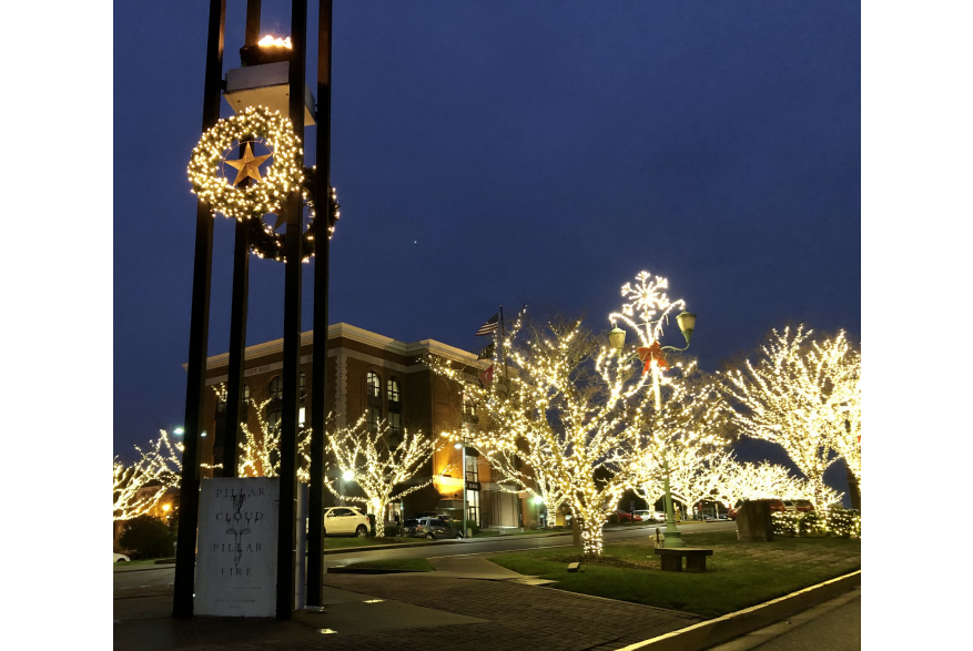 Eternal Flame monument and surrounding town square decorated with Christmas lights