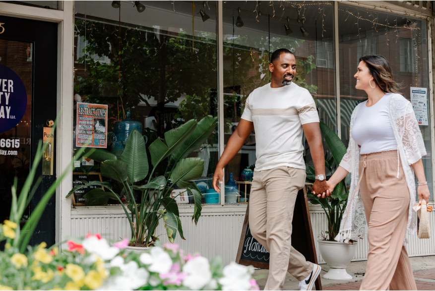 couple walking outside of a pottery gallery