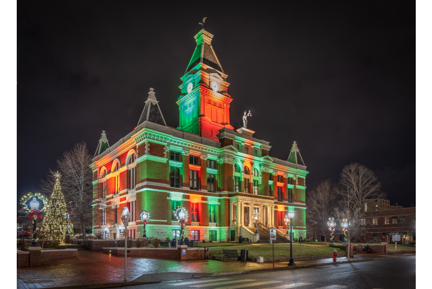 red and green lights cover a historic courthouse