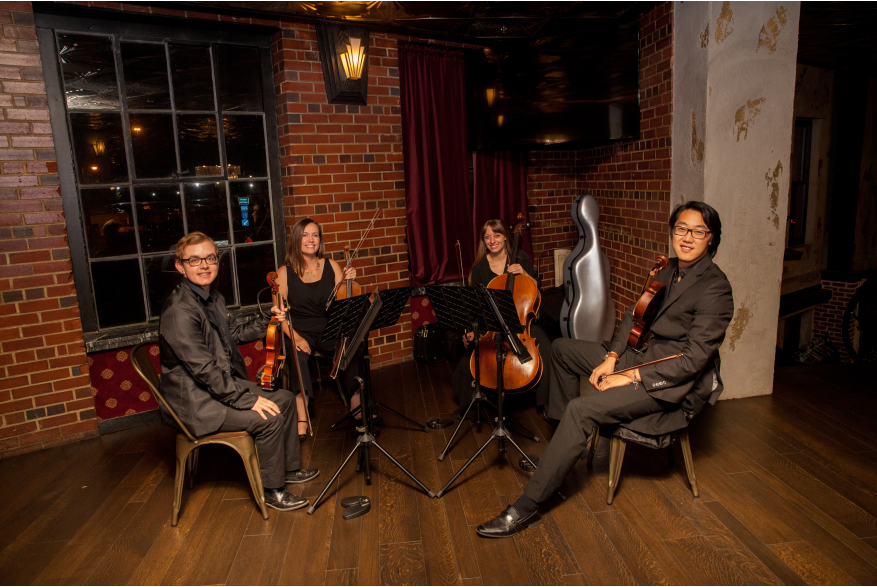 string quartet in front of brick wall