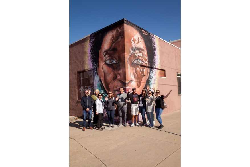 group of attendees in front of Rino street art