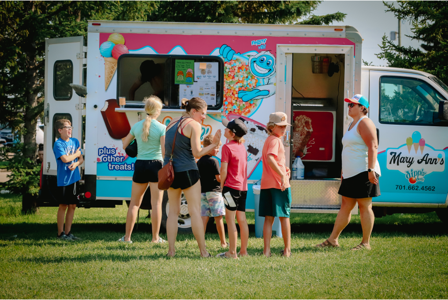 Locals getting ice cream from an ice cream truck.