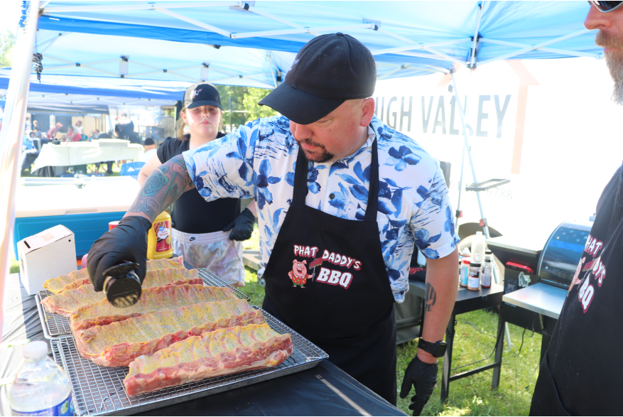 A man seasoning ribs.