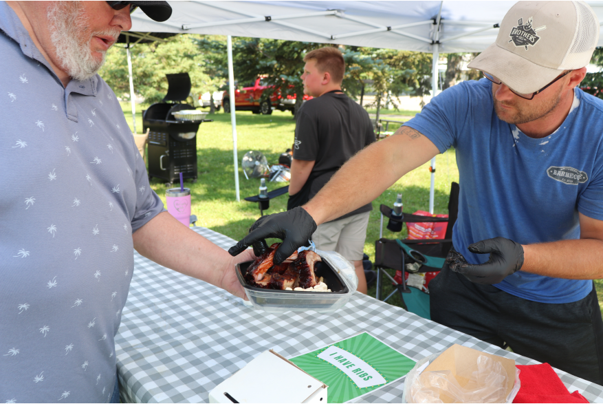 A man serving ribs.