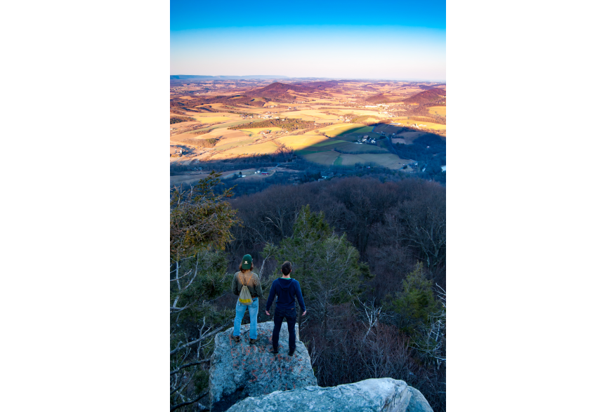 Hikers look out over the view from the Pinnacle