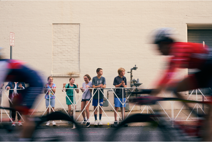 Spectators watch riders zoom by during the 2022 Easton Twilight Criterium in Easton, Pa.