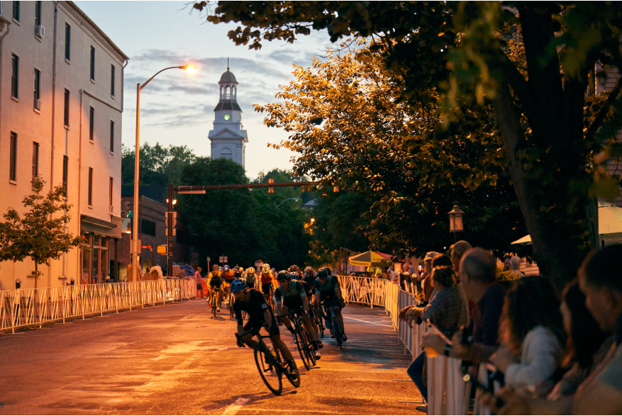 Cyclists ride at dusk during the 2022 Easton Twilight Criterium in Easton, Pa.